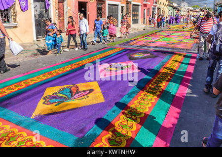 Antigua, Guatemala -  March 19, 2017: Locals make dyed sawdust procession carpets in town with most famous Holy Week celebrations in Latin America Stock Photo