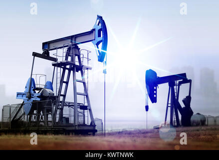 environmental damage from working old oil pumps in rural place against factory Stock Photo