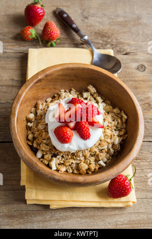 Homemade granola with fresh greek yogurt and strawberries for healthy diet breakfast. Stock Photo