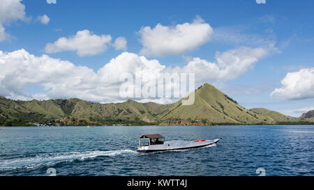 Fishing boat and village along the coast of Labuanbajo, East Nusa Tenggara Island, West Flores, Indonesia Stock Photo