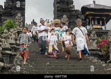 Family of worshipers with wet rice grains on their foreheads at the Pura Besakih Temple, Mount Agung, Bali, Indonesia Stock Photo