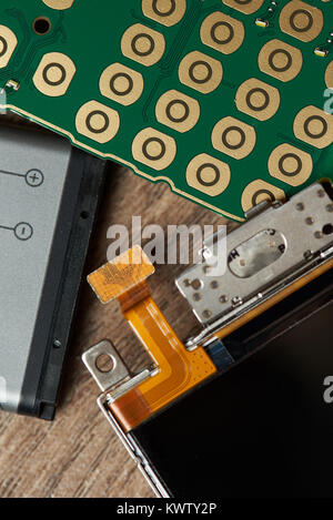 Main parts of mobile phone close up. Battery, board and screen of smartphone Stock Photo