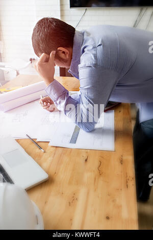 Thoughtful architect with his project, soft focus,  architectural concept Stock Photo