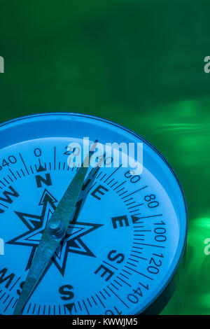 Macro-photo of compass rose face with needle - with copy space. Concept navigation, compass north east. Stock Photo