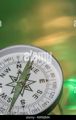 Macro-photo of compass rose face with needle - with copy space. Concept navigation, compass north east Stock Photo