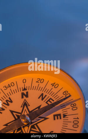 Macro-photo of compass rose face with needle - with copy space. Concept navigation, compass north east. Stock Photo