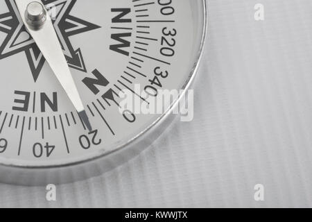 Macro-photo of compass rose face with needle. Concept navigation, compass north. Stock Photo
