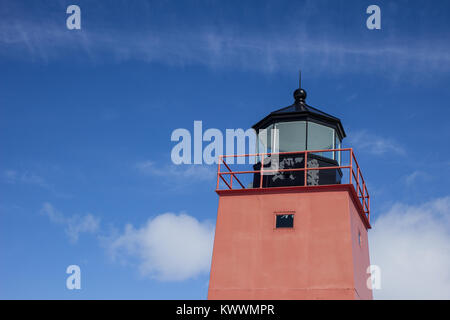 Great Lakes Lighthouse Background. The Charlevoix Michigan Lighthouse on the shore of Lake Michigan set against a sunny blue sky with copy space. Stock Photo