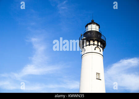 Lighthouse Tower Under Blue Sky With Copy Space. The tower of the Au Sable Lighthouse shot under a sunny blue sky in horizontal orientation with copy Stock Photo