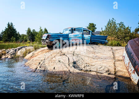 This old car is perched on a rock in Norgate Inlet, Georgian Bay, there are no roads here Stock Photo