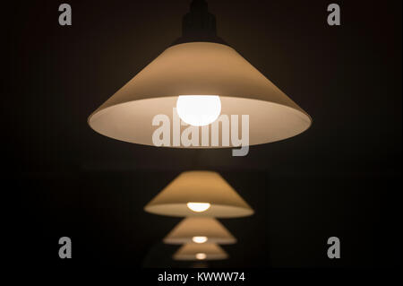 ceiling lamps with glass lampshades, illuminated Stock Photo