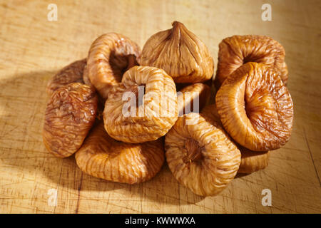 Dried figs on a wood cutting board Stock Photo