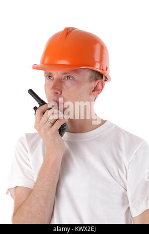 builder talking on portable UHF radio transceiver isolated on white Stock Photo