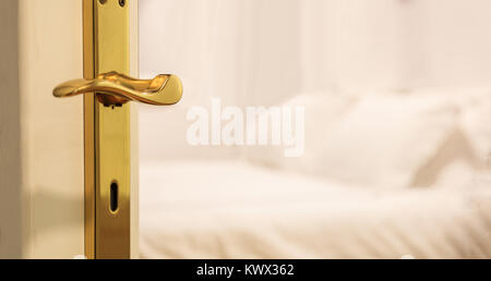 Hotel's blurred bedroom from opened door. White background, close up view, details of the doorway. Stock Photo