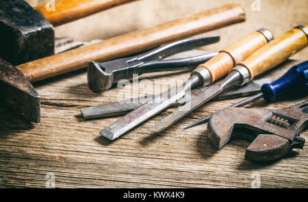 Old hand tools on a wooden surface Stock Photo