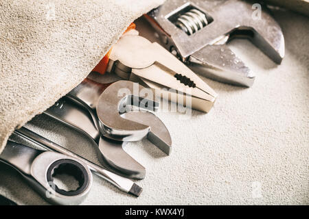 Set of hand tools in a leather pocket Stock Photo