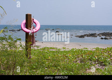 Pink life buoy hanging on wooden pole on beach, Beinan Township, Taitung County, Taiwan Stock Photo