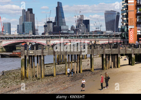 Wooden pier on the south bank of the Thames River with Blackfriars Bridge and the City of London in the background. Stock Photo