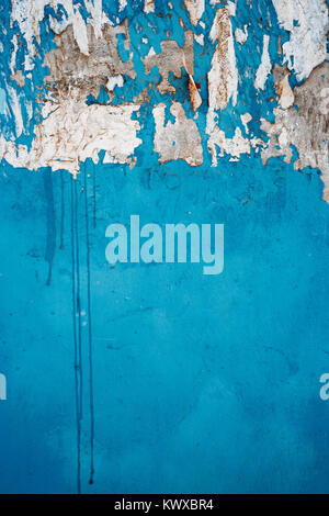 Old city wall painted in blue color half scratched copyspace Stock Photo