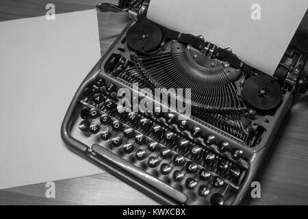 Typewriter ready for use with blank paper installed Stock Photo