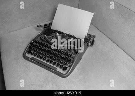 Typewriter ready for use with blank paper installed Stock Photo