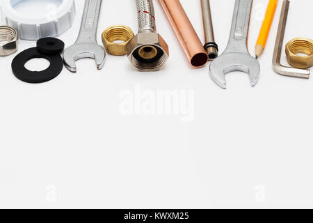 Plumbing essential tools on a plain background Stock Photo