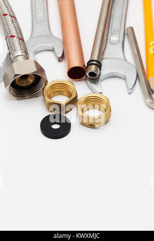 Plumbing essential tools on a plain background Stock Photo