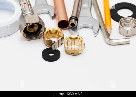 Plumbing essential tools on a plain background Stock Photo