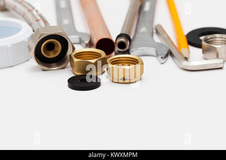 Plumbing essential tools on a plain background Stock Photo