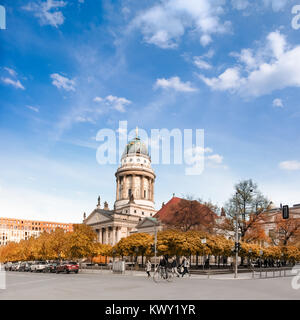 BERLIN, GERMANY - APRIL 30, 2016: French Cathedral on Gendarmenmarkt in evening light. Both visitors and berlin inhabitans enjoy warm evening. This im Stock Photo