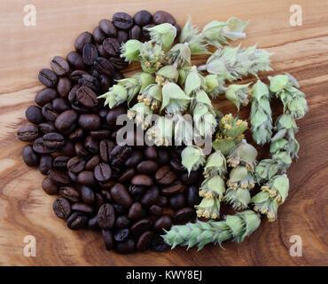 coffee beans and greek mountain tea shaped in yin and yang symbol on olive plate Stock Photo