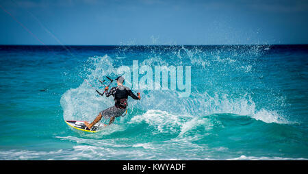 A Kite Surfer films himself as her sends sea spraying in his wake Stock Photo