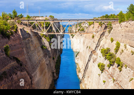 The Corinth Canal is a canal that connects the Gulf of Corinth with the Saronic Gulf in the Aegean Sea. It cuts Isthmus of Corinth and separates Pelop Stock Photo