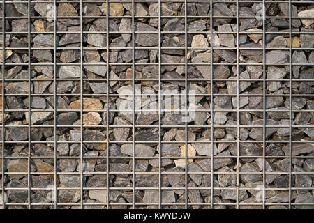 Gabion made of natural stone and metal wire mesh for construction. Stock Photo