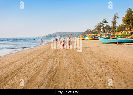 Unidentified tourists and fisherman boats on the Arambol beach in north Goa, India Stock Photo