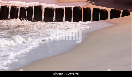 wooden breakwaters in the sand on the Baltic Sea Stock Photo