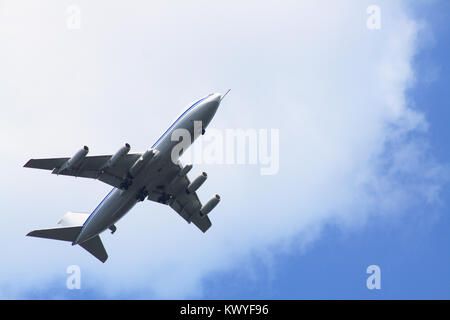 Big passenger airplane on background with blue sky and clouds Stock Photo