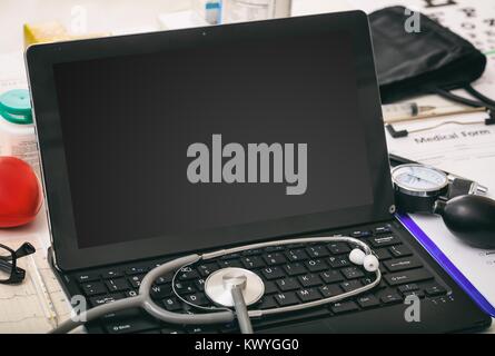Laptop with black screen on a doctor's desk Stock Photo