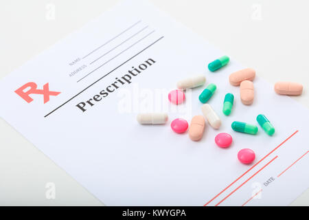 Pills on a blank prescription on white background Stock Photo