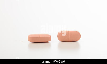 Two pink vitamins isolated on white background Stock Photo