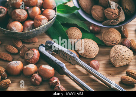 Various nuts and a nutcracker Stock Photo