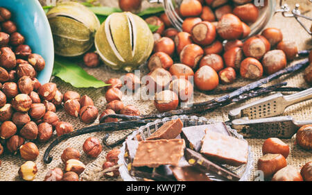 Hazelnuts and chocolate bars on a table Stock Photo