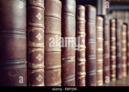 Old leather bound vintage books in a row Stock Photo
