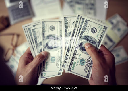 Business man counting savings or payment money with calculator Stock Photo