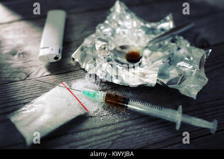 Drug addiction syringe and cooked heroin on spoon Stock Photo