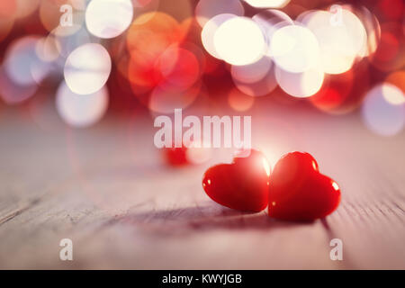 Two valentines day hearts on a wooden background concept for love, dating and romance with copy space Stock Photo