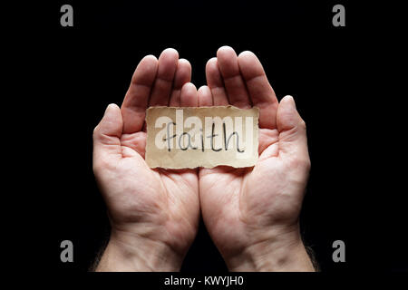 Faith message in cupped hands, concept for love, religion, belief and prayer Stock Photo