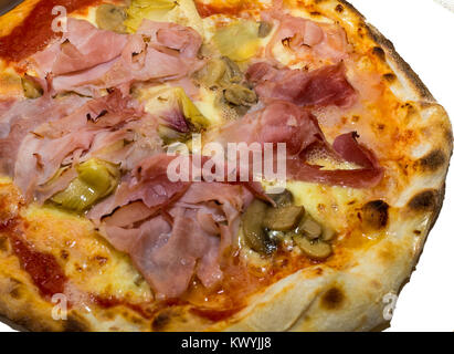 Italian homemade pizza with Ham and mushrooms. Selective focus. Food, italian cuisine and cooking concept. Preparation of the Italian Pizza Stock Photo