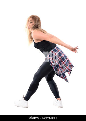 Funky woman jazz dancing aerobics instructor with tousled hair bending and dancing in rhythm. Full body length portrait isolated on white background. Stock Photo