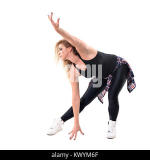 Sweaty woman aerobics instructor dancing jazz dance in bending posture. Full body length portrait isolated on white background. Stock Photo